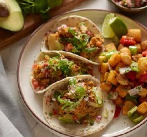 a plate of breakfast tacos and vegetables